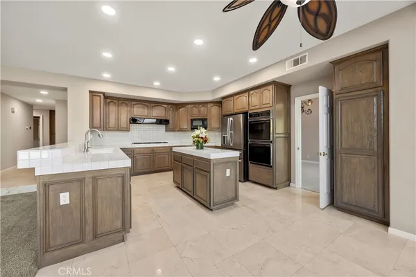 a kitchen with a refrigerator and microwave