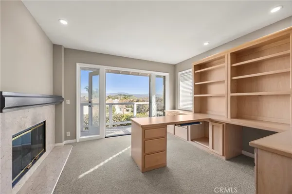 a room with a large window and a kitchen counter top oven