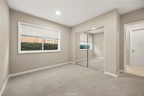 an empty room with windows and closet