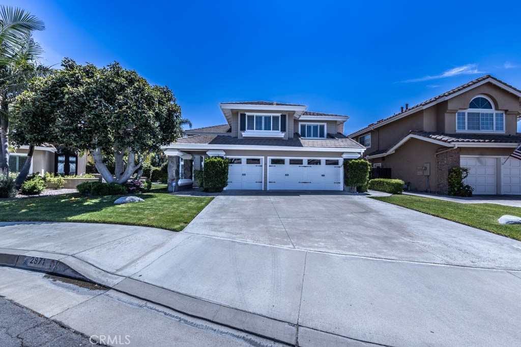 2871 North Roxbury Street Orange, CA 92867 - Photo 4 of 25 a front view of a house with a yard and garage