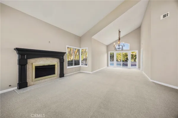 a view of a livingroom with an empty space and a fireplace