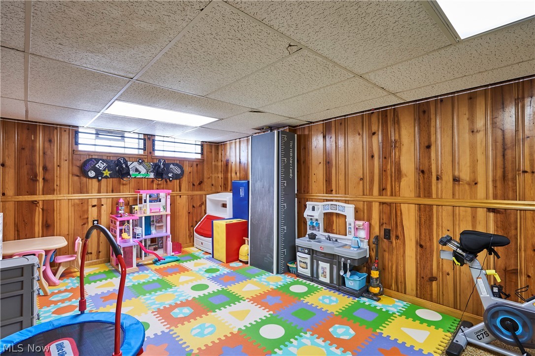 28322 Forest Road Willowick, OH 44095 - Photo 29 of 32 Playroom featuring wooden walls and a drop ceiling