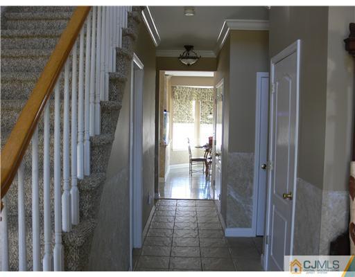 10 Bernadette Road Morganville, NJ 07751 - Photo 2 of 24 a view of entryway and hall with wooden floor
