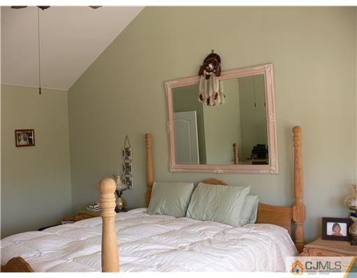 10 Bernadette Road Morganville, NJ 07751 - Photo 12 of 24 a bedroom with a bed and a mirror