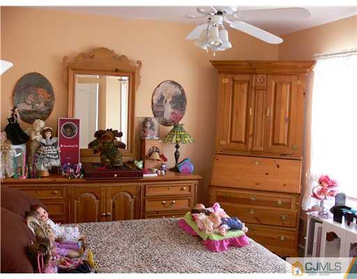 10 Bernadette Road Morganville, NJ 07751 - Photo 14 of 24 a bed room with a bed mirror and a window