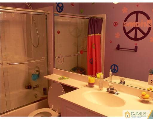 10 Bernadette Road Morganville, NJ 07751 - Photo 17 of 24 a bathroom with a sink and a mirror