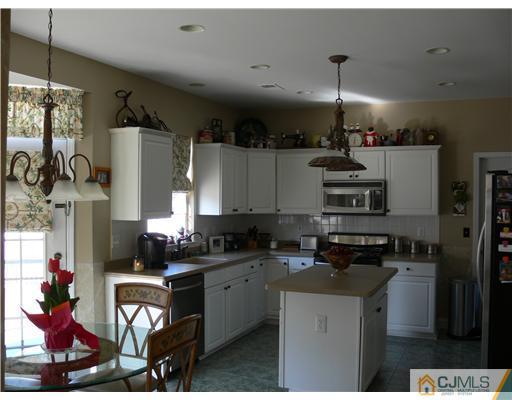 10 Bernadette Road Morganville, NJ 07751 - Photo 7 of 24 a kitchen with stainless steel appliances kitchen island granite countertop a stove a sink a refrigerator and a cabinets