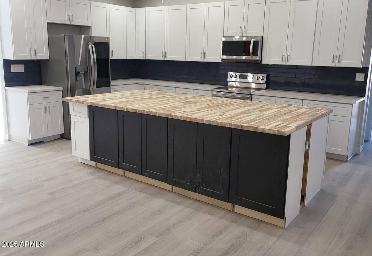 2511 East Broadway Road Phoenix, AZ 85040 - Photo 1 of 17 a kitchen with a refrigerator sink and cabinets