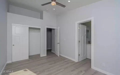 an empty room with wooden floor and closet