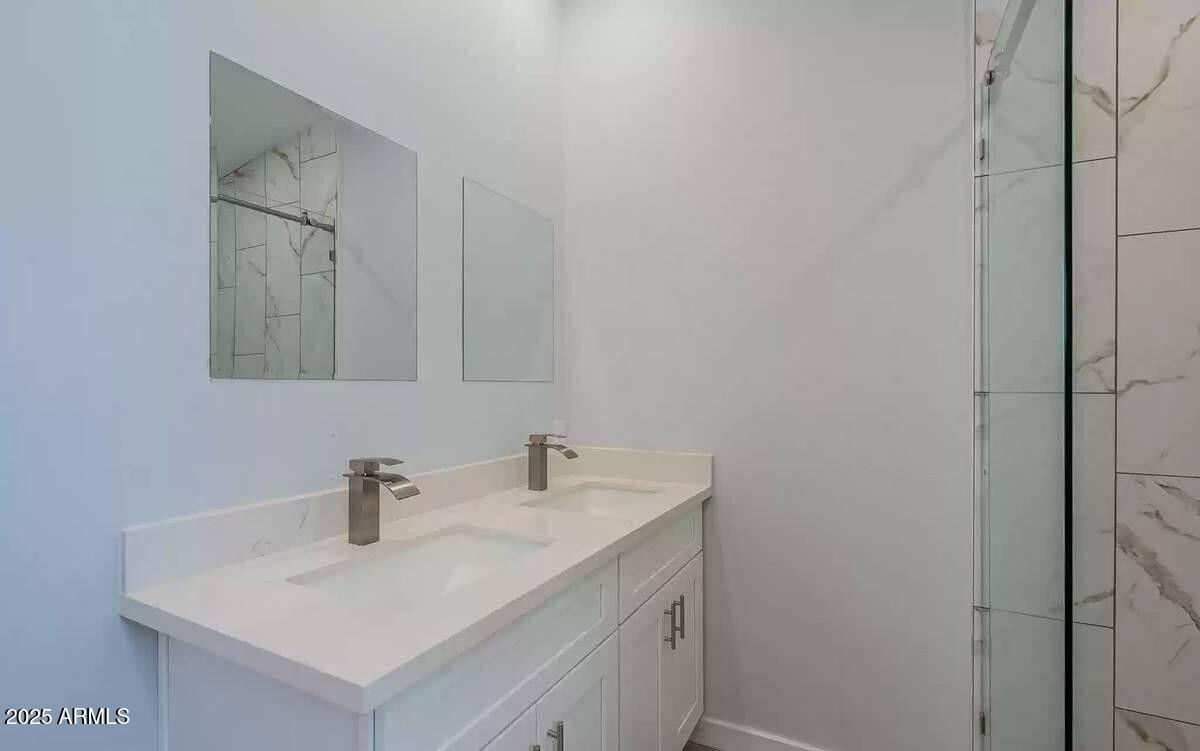 2511 East Broadway Road Phoenix, AZ 85040 - Photo 14 of 17 a bathroom with a sink and a mirror