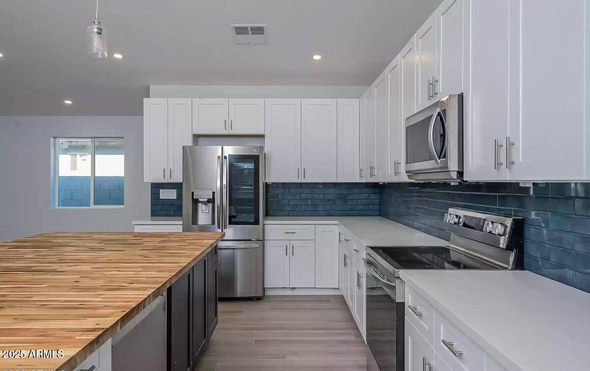 2511 East Broadway Road Phoenix, AZ 85040 - Photo 2 of 17 a kitchen with stainless steel appliances granite countertop a sink stove and refrigerator