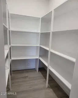 a view of walk in closet with empty racks