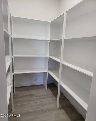 a view of walk in closet with empty racks