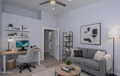 a living room with furniture and a wooden floor