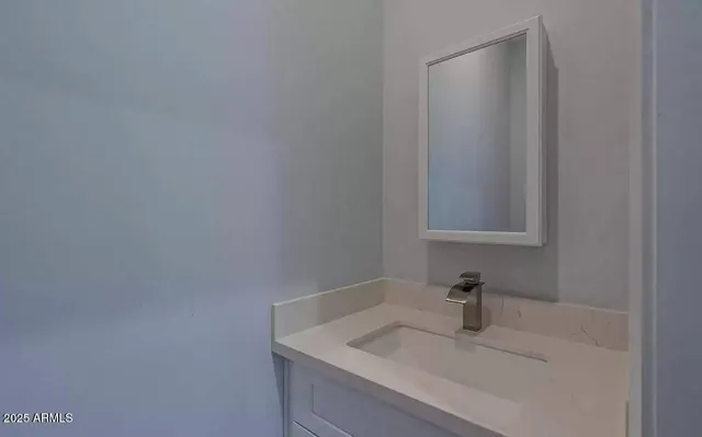 a bathroom with a sink and vanity