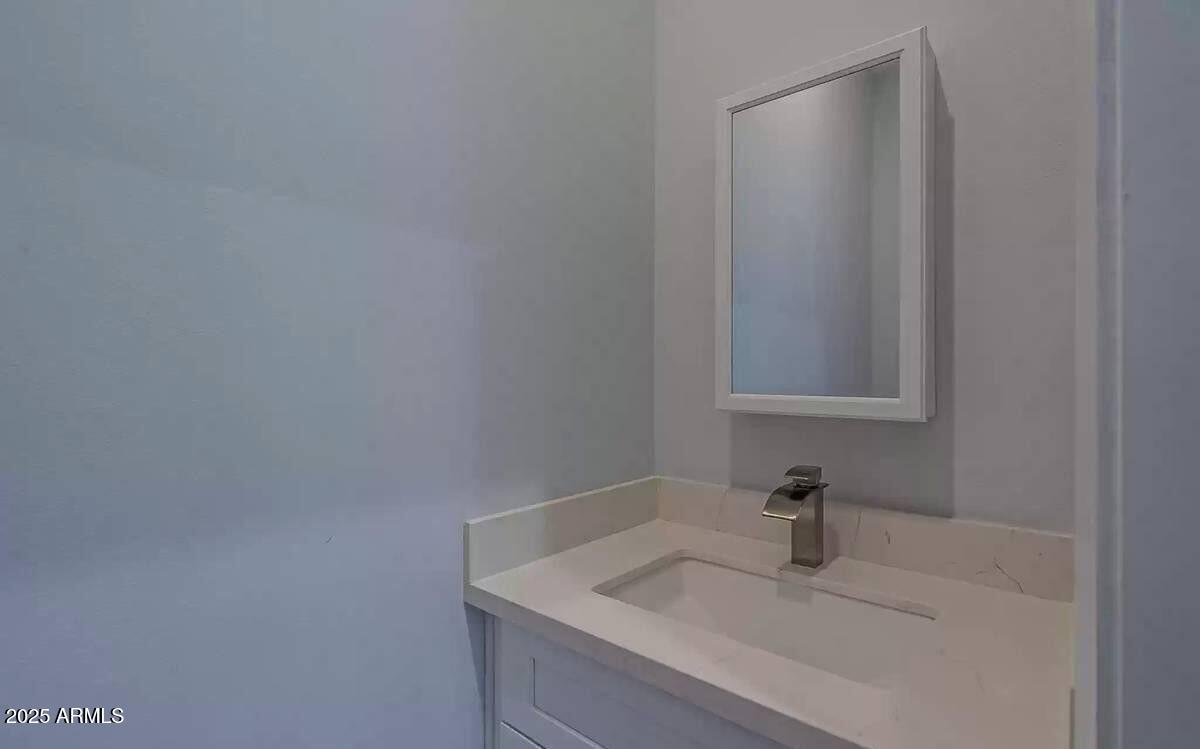 2511 East Broadway Road Phoenix, AZ 85040 - Photo 5 of 17 a bathroom with a sink and vanity