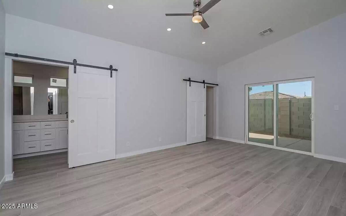 2511 East Broadway Road Phoenix, AZ 85040 - Photo 8 of 17 wooden floor in an empty room with a mirror