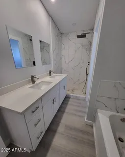 a bathroom with a sink a mirror and a bathtub