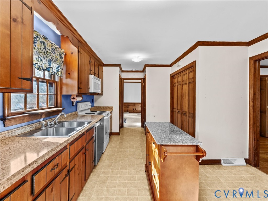 4701 Black Oak Road North Chesterfield, VA 23237 - Photo 16 of 47 a large kitchen with granite countertop a sink and a refrigerator