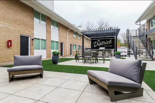 a view of a patio with couches and a table and chairs