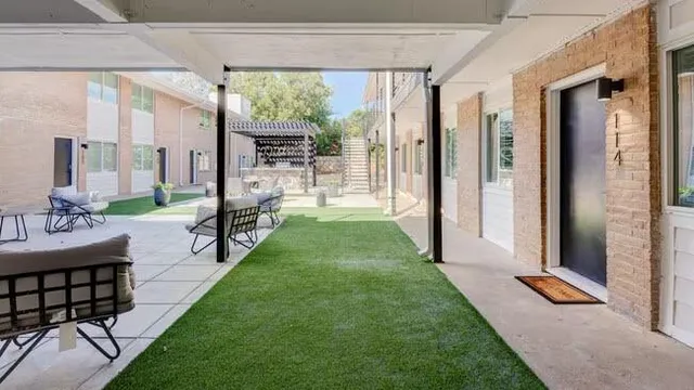 a view of a porch with a table and chairs
