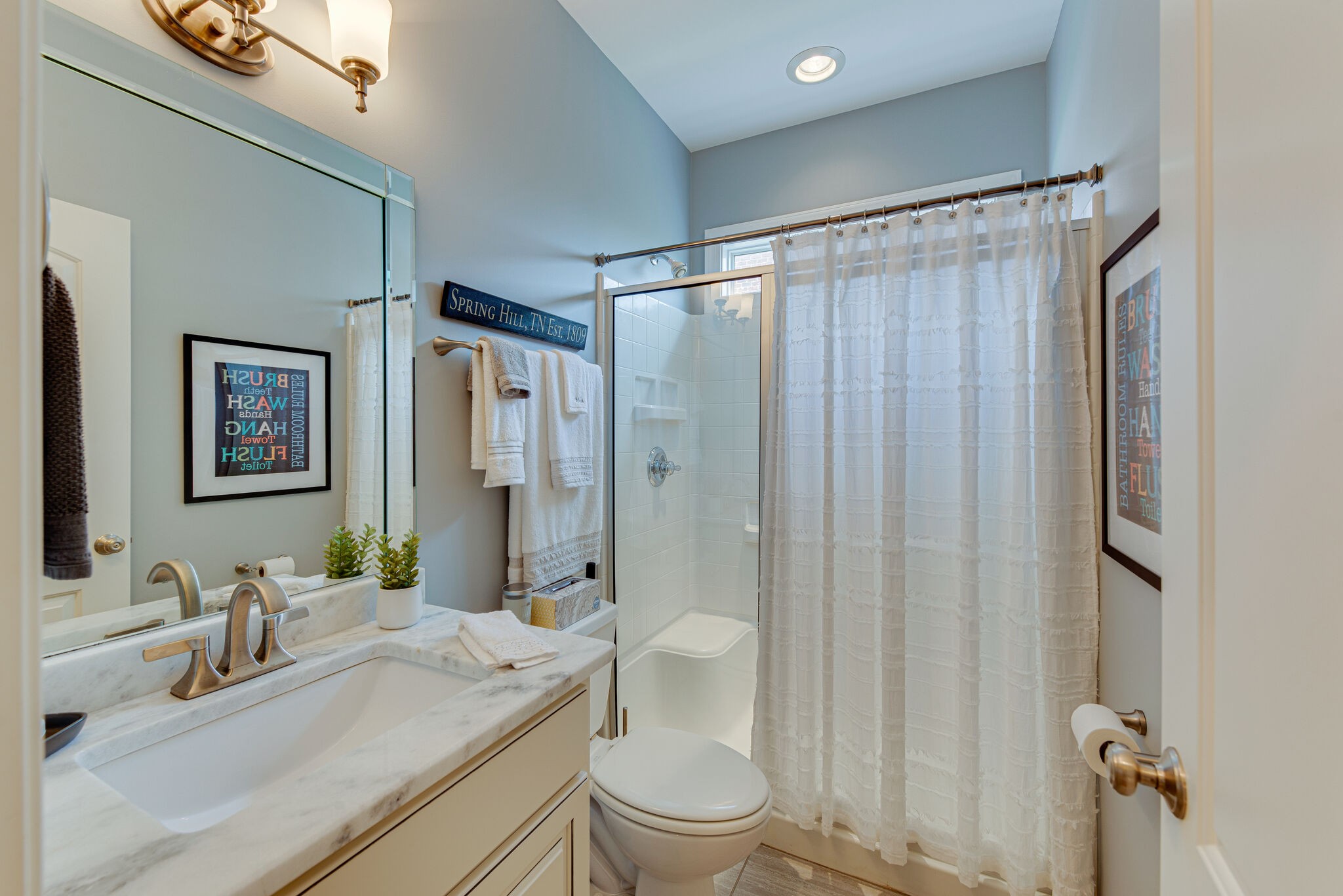 1027 Red Pepper Ridge Spring Hill, TN 37174 - Photo 23 of 38 a bathroom with a sink a toilet and shower