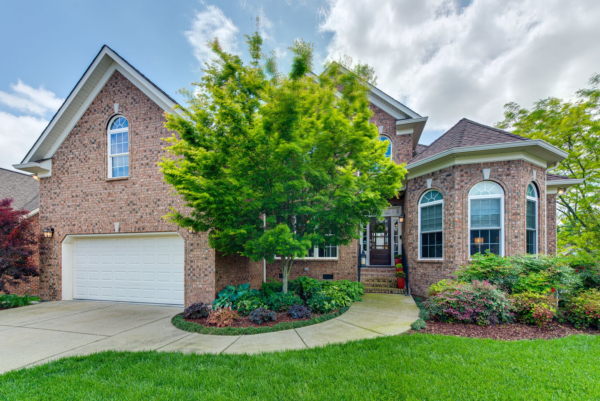 1027 Red Pepper Ridge Spring Hill, TN 37174 - Photo 4 of 38 a front view of a house with a yard and garage