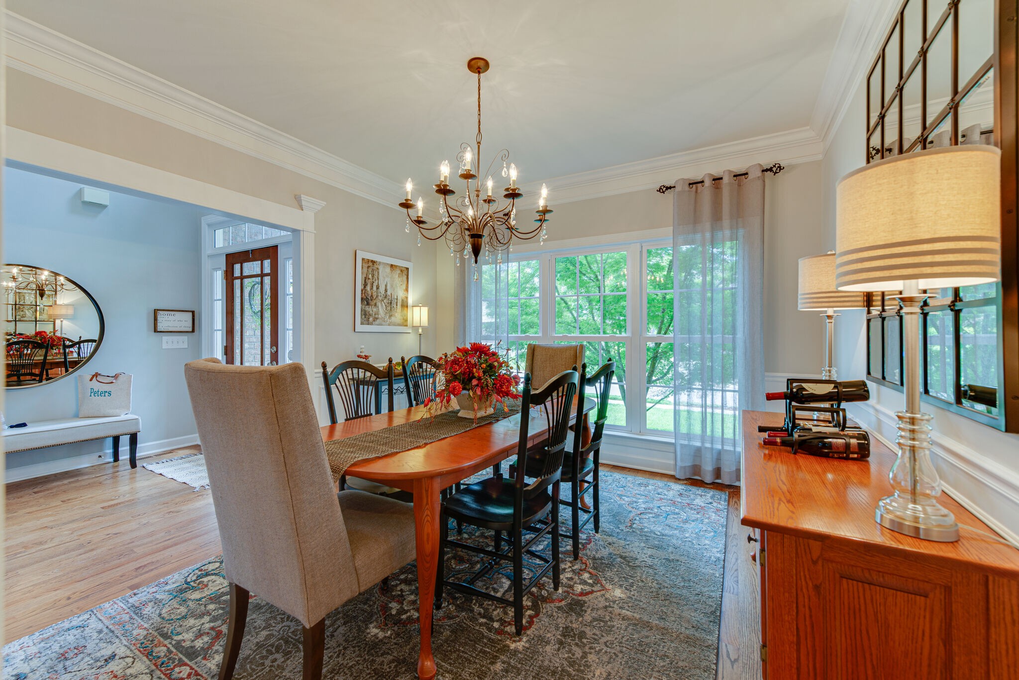 1027 Red Pepper Ridge Spring Hill, TN 37174 - Photo 6 of 38 a dining room with furniture a chandelier and wooden floor
