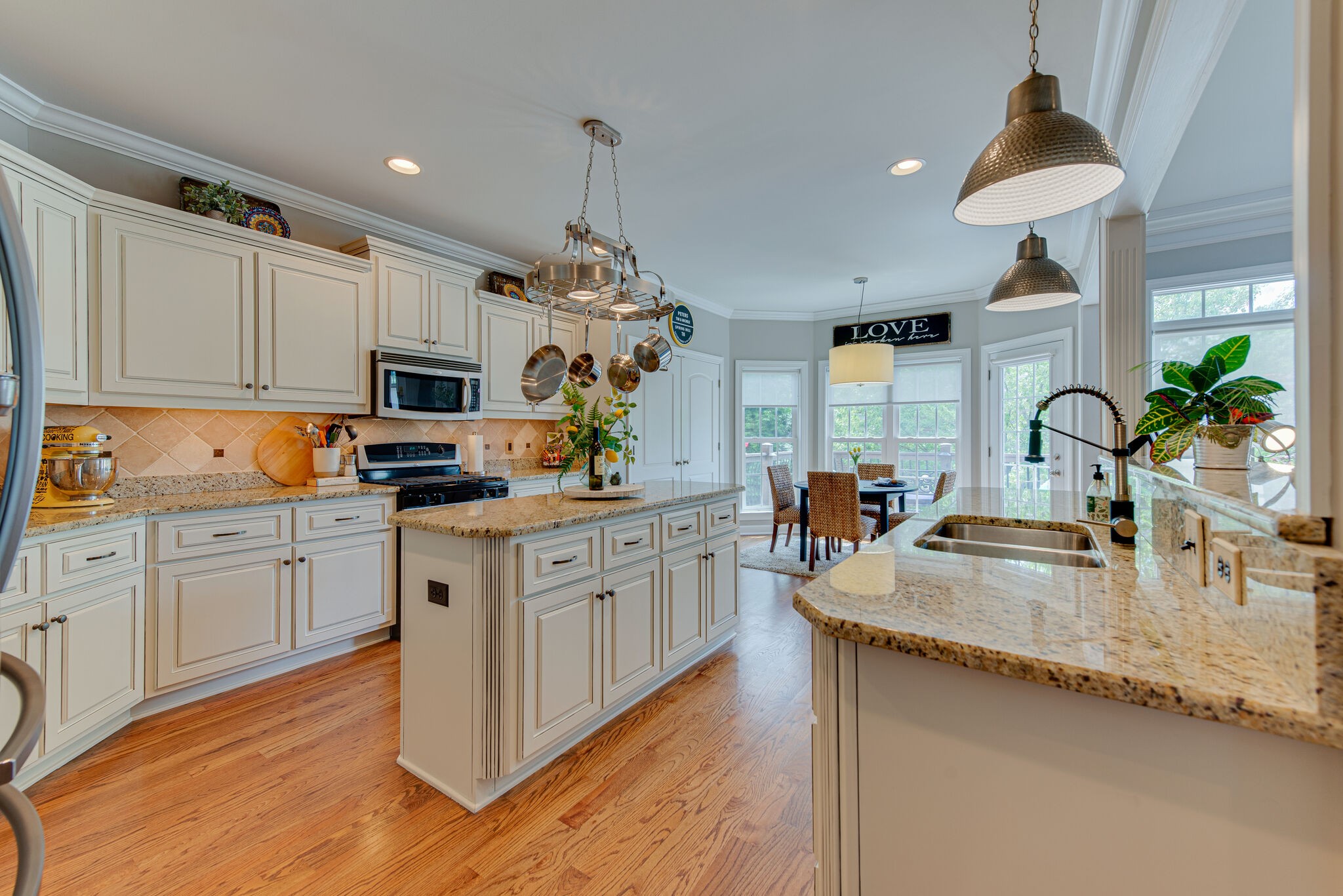 1027 Red Pepper Ridge Spring Hill, TN 37174 - Photo 8 of 38 a kitchen with granite countertop a sink stainless steel appliances and cabinets
