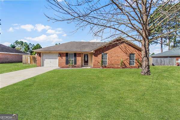 a view of a house with a backyard