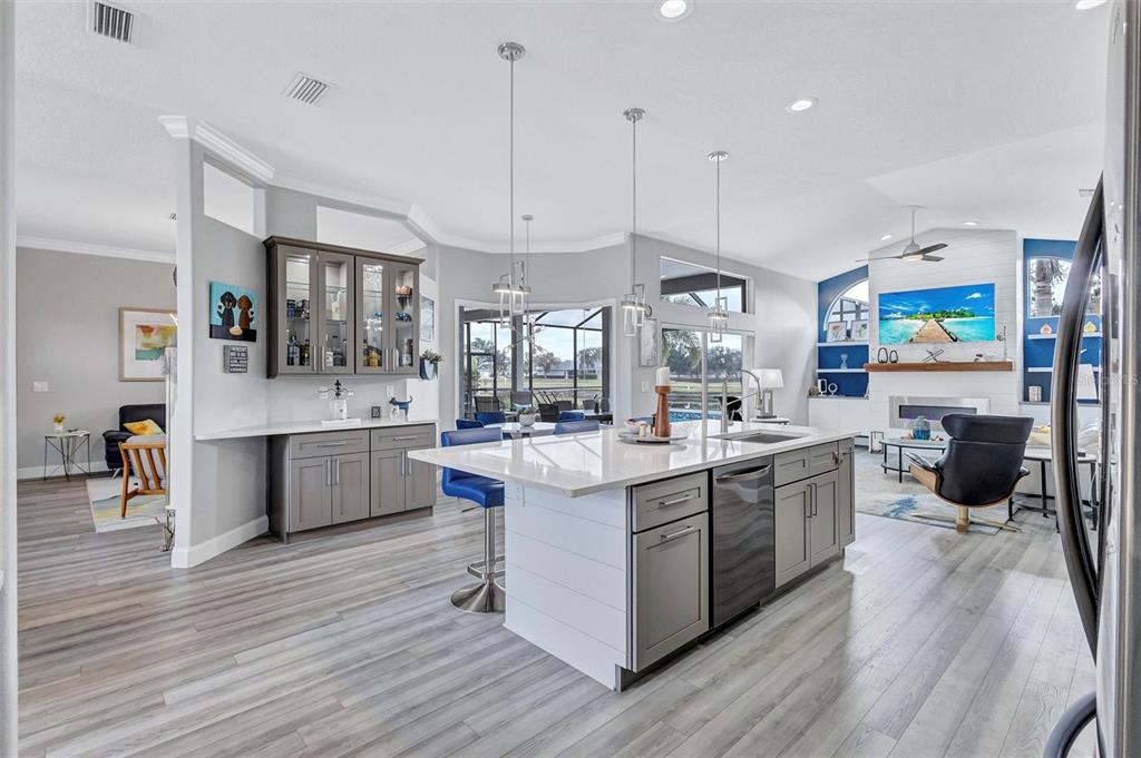 8409 29th Street East Parrish, FL 34219 - Photo 19 of 65 a large kitchen with stainless steel appliances granite countertop a lot of counter space and wooden floor
