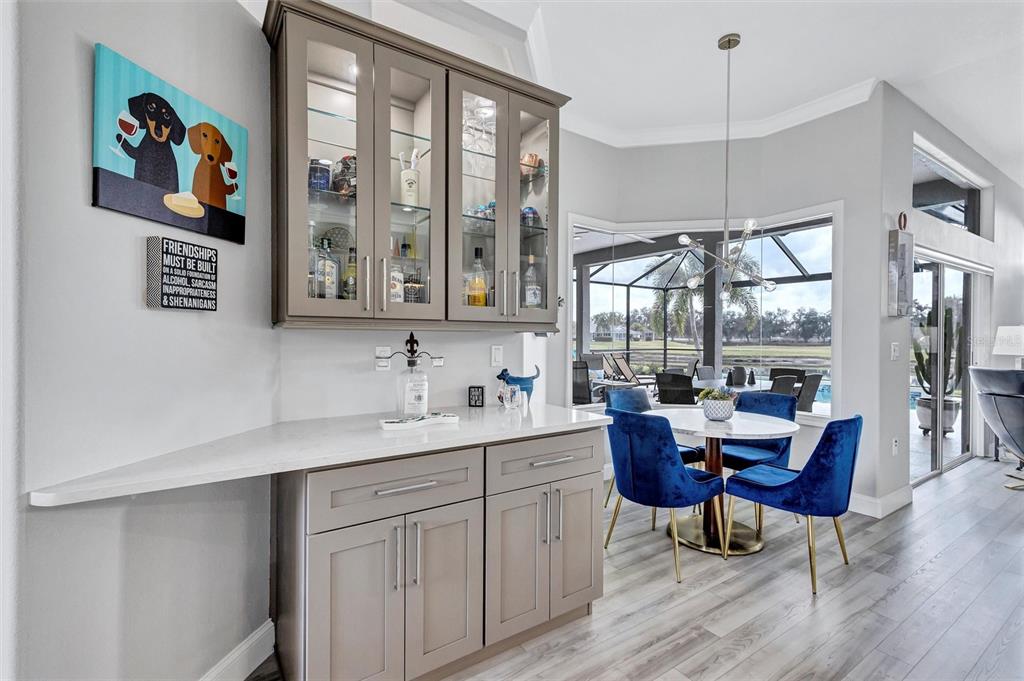8409 29th Street East Parrish, FL 34219 - Photo 20 of 65 a view of a dining room with furniture large windows and wooden floor