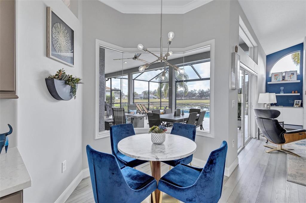 8409 29th Street East Parrish, FL 34219 - Photo 21 of 65 a view of a dining room with furniture window and wooden floor