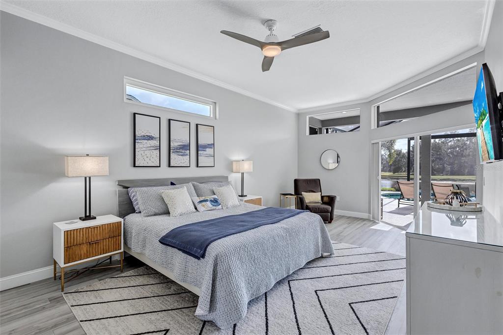 8409 29th Street East Parrish, FL 34219 - Photo 26 of 65 a bedroom with a large bed and a lamp on table