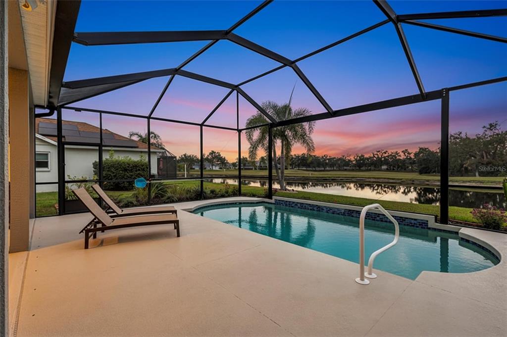 8409 29th Street East Parrish, FL 34219 - Photo 3 of 65 a view of a swimming pool with a lounge chair