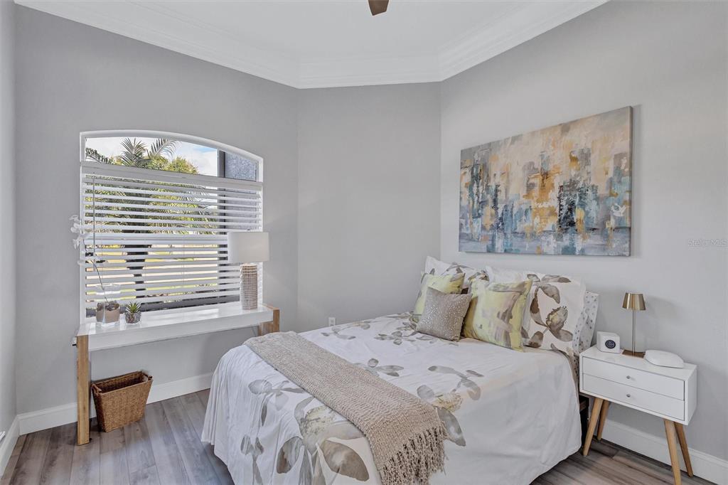 8409 29th Street East Parrish, FL 34219 - Photo 31 of 65 a bedroom with a bed and a desk