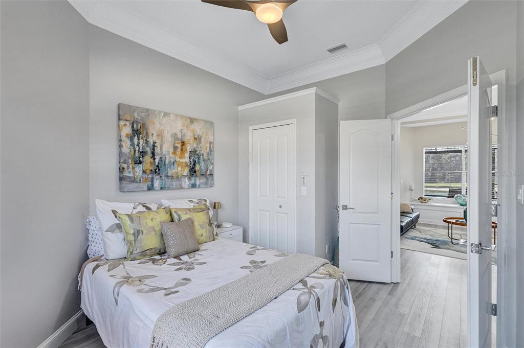 8409 29th Street East Parrish, FL 34219 - Photo 33 of 65 a bedroom with a bed and a painting on the wall