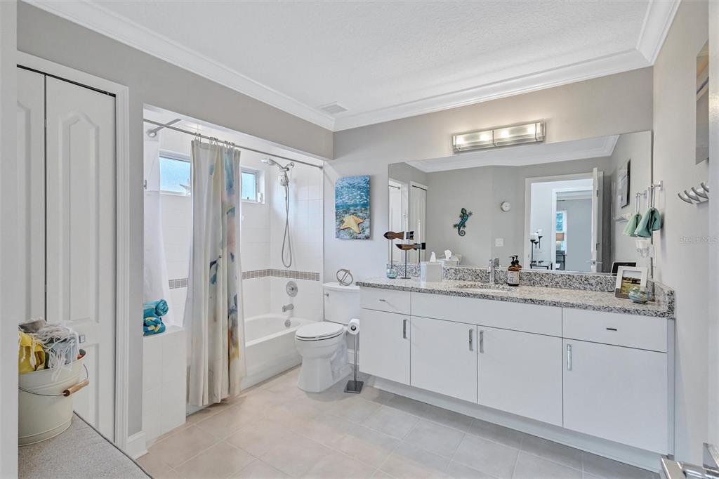 8409 29th Street East Parrish, FL 34219 - Photo 36 of 65 a spacious bathroom with a granite countertop sink mirror and toilet