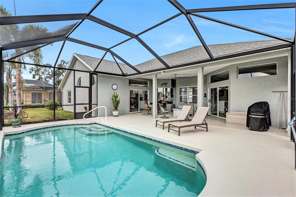 8409 29th Street East Parrish, FL 34219 - Photo 41 of 65 a view of a swimming pool with a lounge chair