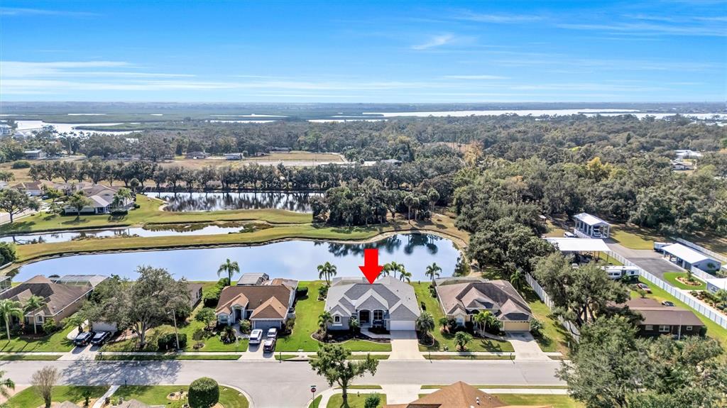 8409 29th Street East Parrish, FL 34219 - Photo 46 of 65 an aerial view of residential building and lake view