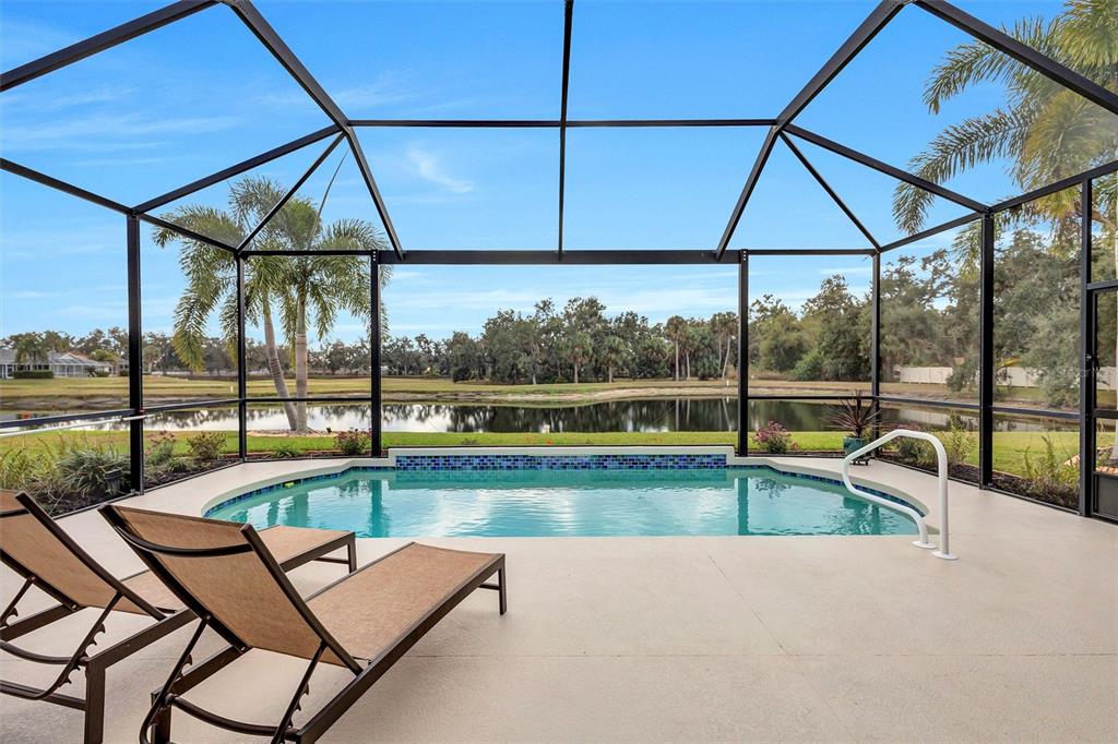 8409 29th Street East Parrish, FL 34219 - Photo 5 of 65 a view of swimming pool with seating area and trees in the background