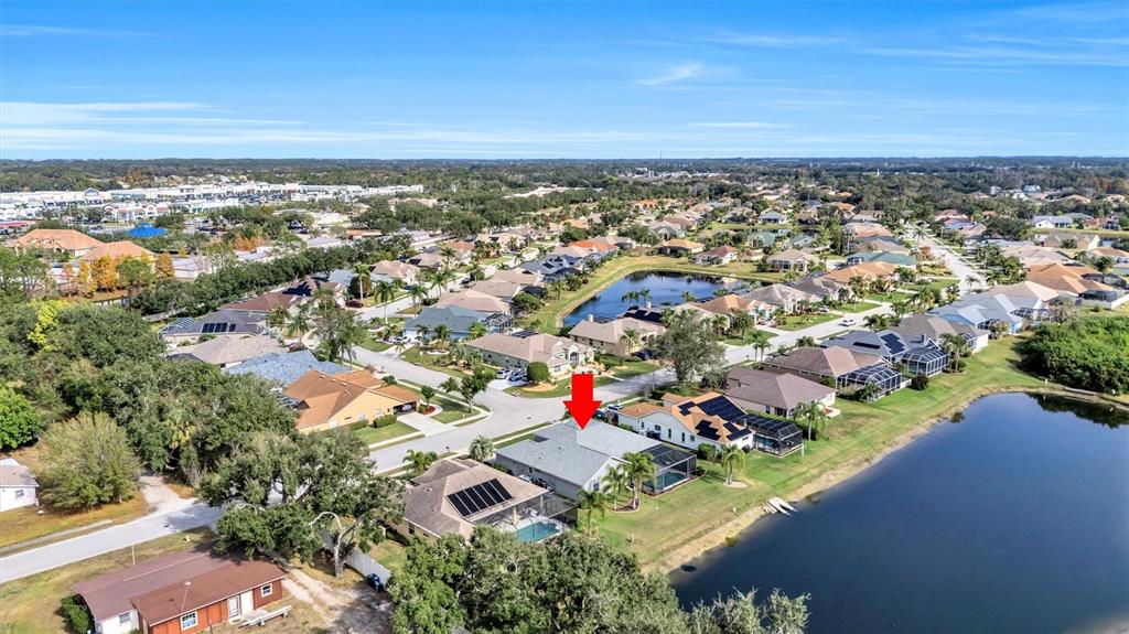 8409 29th Street East Parrish, FL 34219 - Photo 58 of 65 an aerial view of residential houses with outdoor space and trees