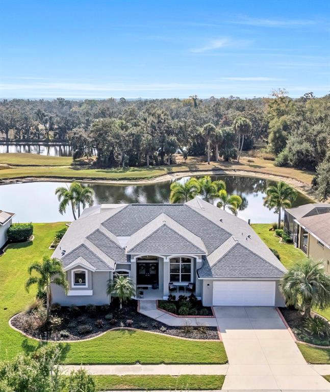 8409 29th Street East Parrish, FL 34219 - Photo 65 of 65 an aerial view of a house with a garden and lake view