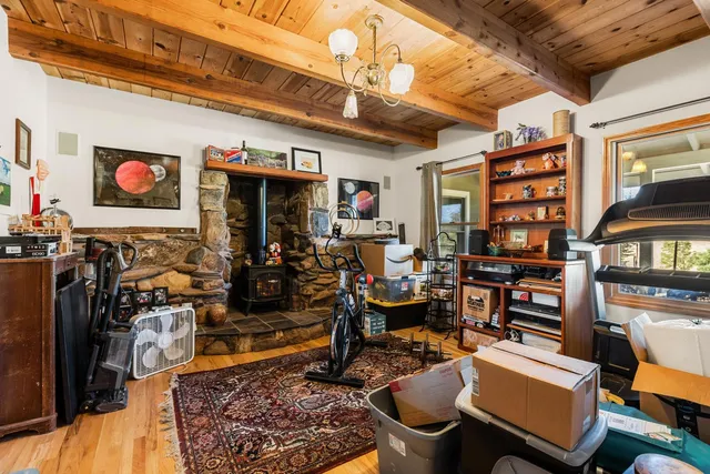 a view of a room with guitars and wooden floor