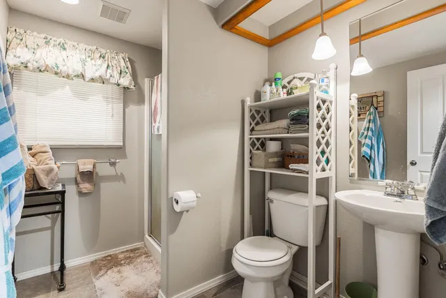 a bathroom with a sink toilet and shower