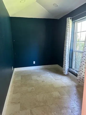 a view of livingroom with an empty space and window