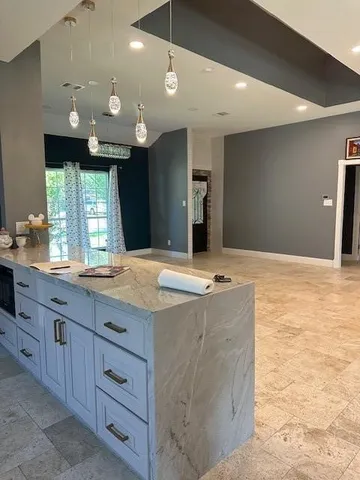 a bathroom with a granite countertop sink a large mirror and a shower
