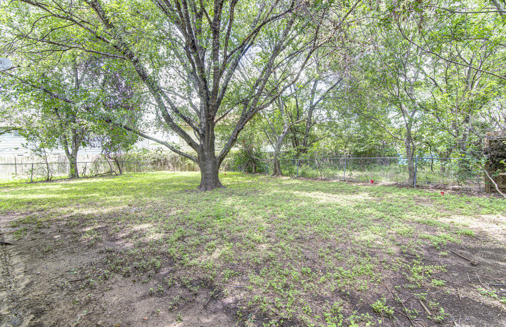 5301 Indio Circle, Unit A Austin, TX 78745 - Photo 22 of 25 Mature trees shade this generous, verdant backyard space, perfect for outdoor activities.
