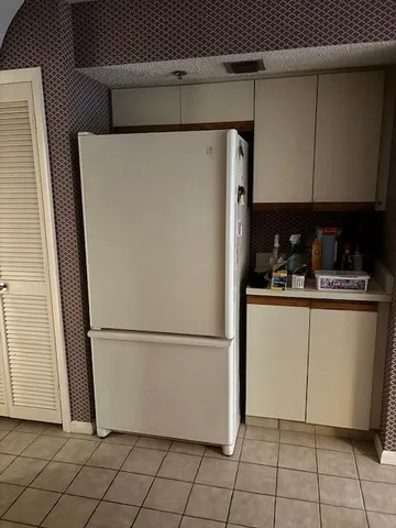 a living room with couches large mirror with wooden floor