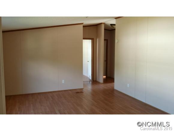 91 Austin Road Clyde, NC 28721 - Photo 14 of 23 a open hall with wooden floor